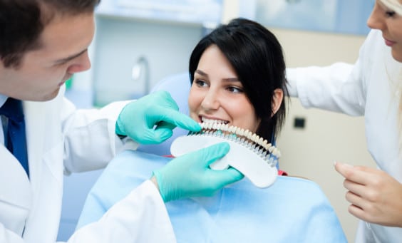 A young woman gets assessed for teeth whitening