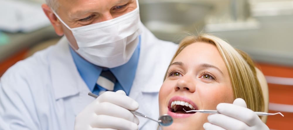A woman receives a dental procedure