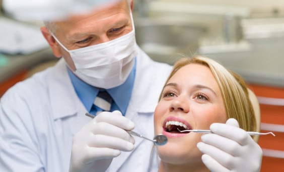 A woman receives a dental procedure