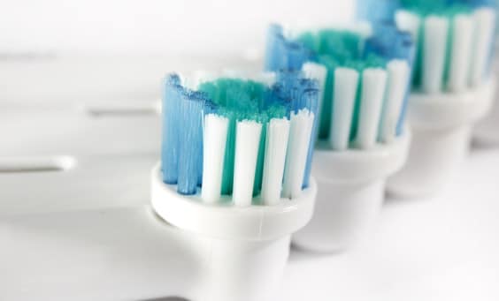 A few electric toothbrush heads lined up side by side