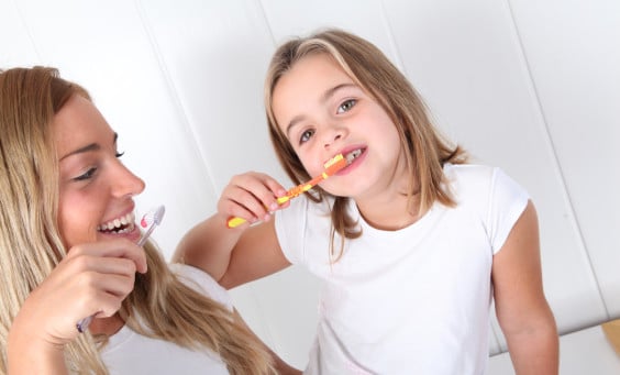Mother and Daughter Brushing Their Teeth