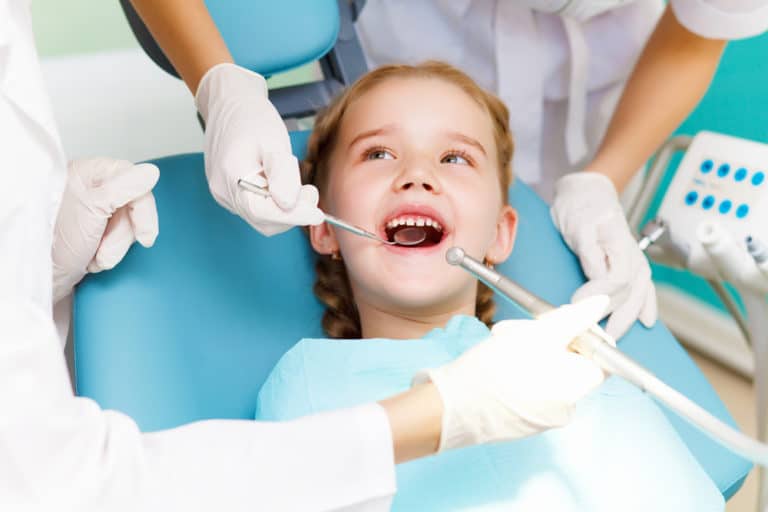 little girl in the dentist chair