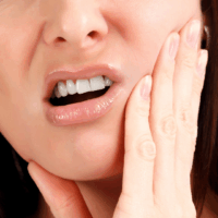 A darkened or discolored tooth